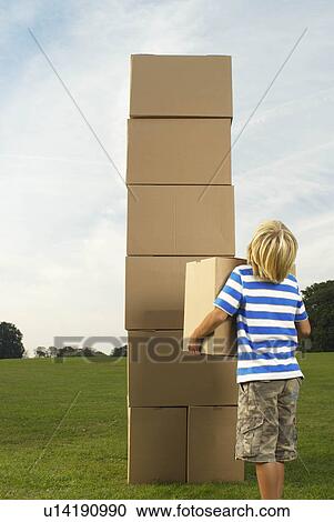 boy looking at box tower View Large Photo Image Stock Image - boy looking at box tower. Fotosearch