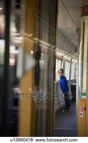 Boy looking out train window View Large Photo Image Stock Photo - Boy looking out train window. Fotosearch