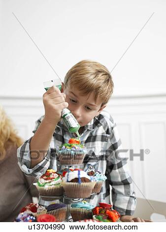 Boy making Cupcakes View Large Photo Image Stock Image - Boy making Cupcakes. Fotosearch