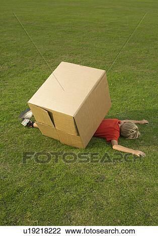 Stock Image - boy under box. Fotosearch