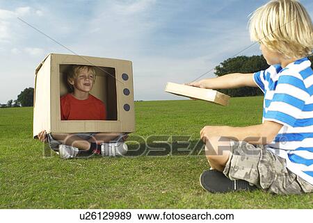 boy watching other boy in box tv View Large Photo Image Stock Photo - boy watching other boy in box tv. Fotosearch