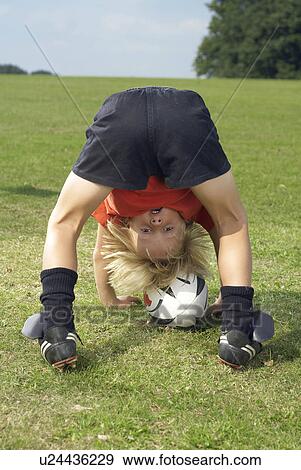 Stock Photo - boy with rugby ball. Fotosearch