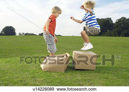 Stock Photo - boys jumping on boxes. Fotosearch