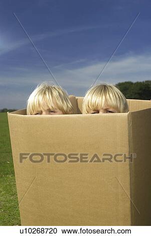 Stock Image - boys looking out of box. Fotosearch