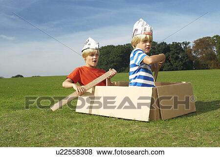 boys using box as imaginary boat View Large Photo Image Stock Photo - boys using box as imaginary boat. Fotosearch