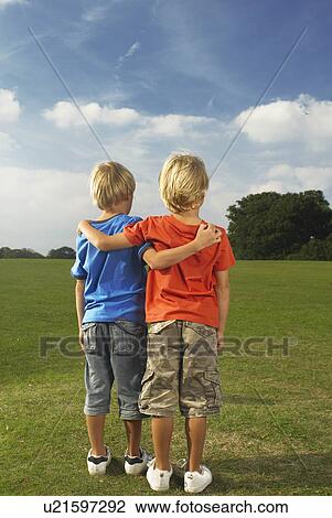 Stock Image - boys with arms around each other. Fotosearch