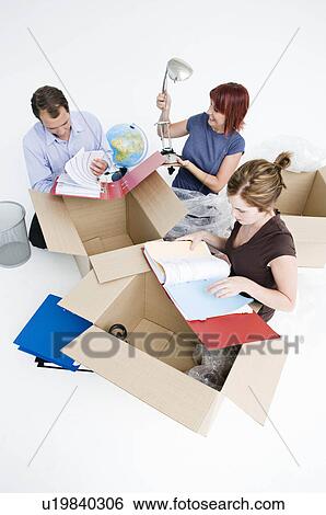 Business colleagues unpack office boxes View Large Photo Image Stock Photograph - Business colleagues unpack office boxes. Fotosearch