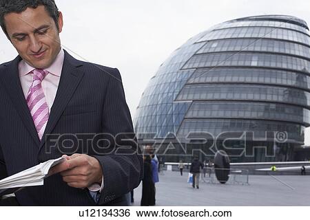Business man reading news paper View Large Photo Image Stock Photograph - Business man reading news paper. Fotosearch