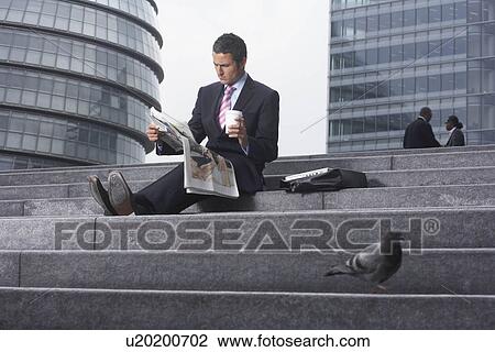 Business man reading paper outside View Large Photo Image Stock Image - Business man reading paper outside. Fotosearch