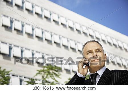 Stock Photography - Business man talking on his phone. Fotosearch