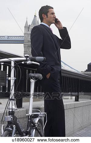 Business man using a mobile phone View Large Photo Image Stock Photo - Business man using a mobile phone. Fotosearch