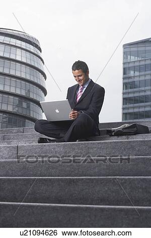 Business man with laptop outside View Large Photo Image Stock Photograph - Business man with laptop outside. Fotosearch