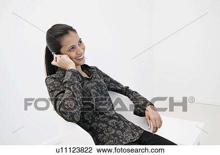 Stock Image - Business woman on the phone.. Fotosearch