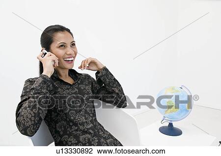 Stock Image - Business woman on the phone.. Fotosearch