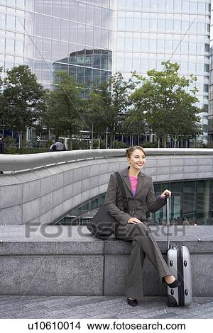 Business woman sitting with luggage View Large Photo Image Picture - Business woman sitting with luggage. Fotosearch