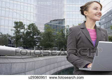 Business woman using laptop outside View Large Photo Image Stock Image - Business woman using laptop outside. Fotosearch