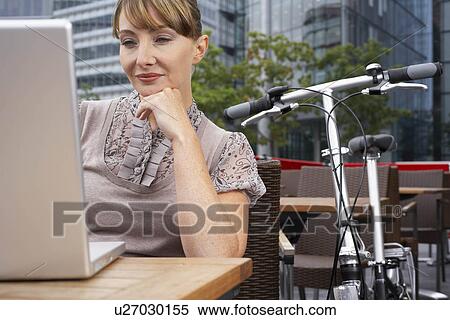 Business woman using laptop outside View Large Photo Image Stock Photography - Business woman using laptop outside. Fotosearch