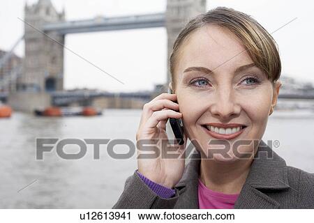 Business woman using mobile outside View Large Photo Image Stock Image - Business woman using mobile outside. Fotosearch