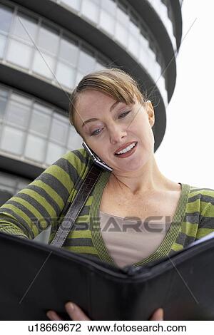 Business woman using mobile outside View Large Photo Image Stock Image - Business woman using mobile outside. Fotosearch