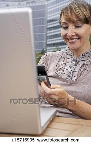 Business woman using mobile outside View Large Photo Image Stock Photography - Business woman using mobile outside. Fotosearch