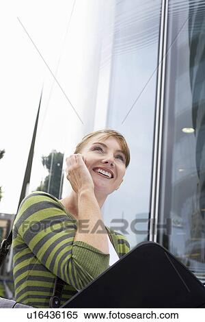 Stock Photography - Business woman using mobile outside. Fotosearch