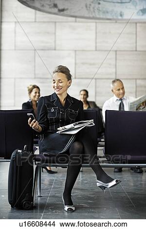 Business woman with a suitcase, waiting View Large Photo Image Picture - Business woman with a suitcase, waiting. Fotosearch
