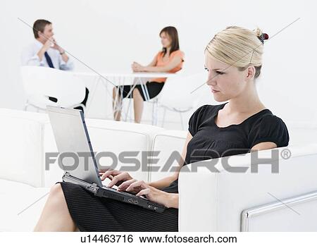 Stock Photograph - Business woman working on her laptop. Fotosearch