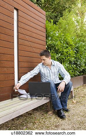 Businessman checking his notes View Large Photo Image Stock Image - Businessman checking his notes. Fotosearch