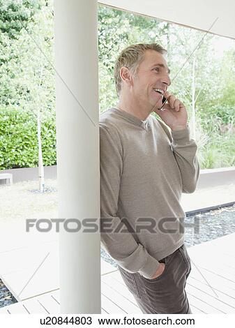 Businessman talking in his mobile phone View Large Photo Image Stock Image - Businessman talking in his mobile phone. Fotosearch