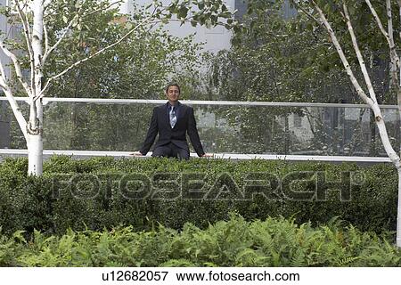 Stock Photo - businessman using laptop outside. Fotosearch