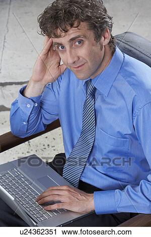 Businessman with laptop View Large Photo Image Stock Image - Businessman with laptop. Fotosearch