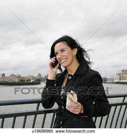 Businesswoman on phone with lunch View Large Photo Image Stock Photography - Businesswoman on phone with lunch. Fotosearch