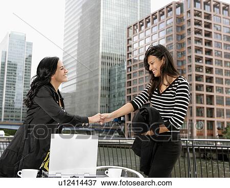 Stock Photo - Businesswomen meeting at cafe. Fotosearch