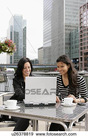 Stock Photo - Businesswomen meeting at cafe. Fotosearch
