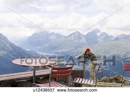 Stock Photo - Child running in field towards mountains. Fotosearch
