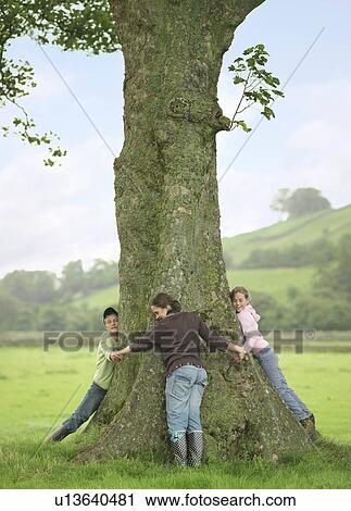 Stock Image - Children Hugging Tree. Fotosearch