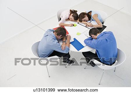 Colleagues asleep on an office table. View Large Photo Image Stock Photo - Colleagues asleep on an office table.. Fotosearch