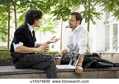Stock Photo - Colleagues having coffee. Fotosearch