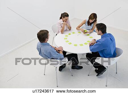 Colleagues working out their fortunes View Large Photo Image Stock Photo - Colleagues working out their fortunes. Fotosearch
