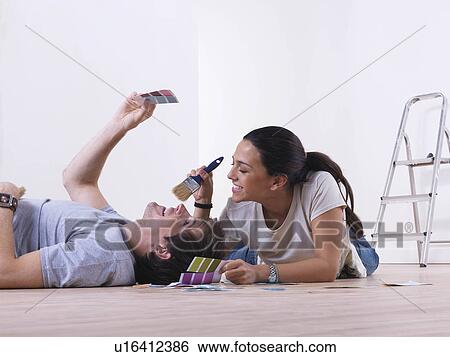 Couple choosing paint colours. View Large Photo Image Stock Photograph - Couple choosing paint colours.. Fotosearch