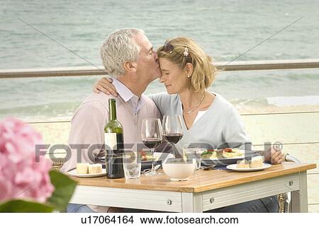 Picture - Couple dining at seaside restaurant. Fotosearch