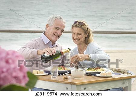 Picture - Couple dining at seaside restaurant. Fotosearch