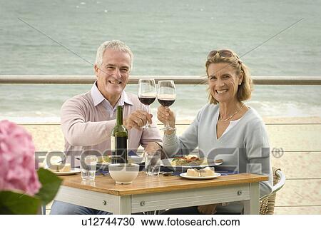 Couple dining at seaside restaurant View Large Photo Image Stock Image - Couple dining at seaside restaurant. Fotosearch