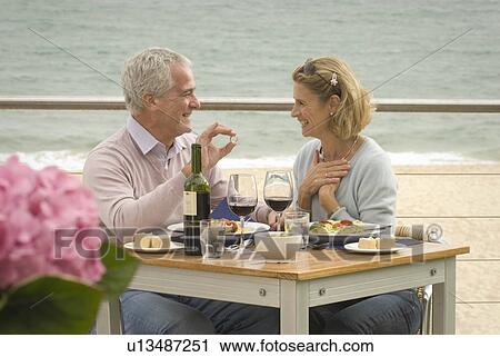 Couple dining at seaside restaurant View Large Photo Image Stock Image - Couple dining at seaside restaurant. Fotosearch