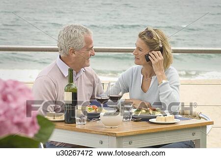 Couple dining at seaside restaurant View Large Photo Image Stock Image - Couple dining at seaside restaurant. Fotosearch