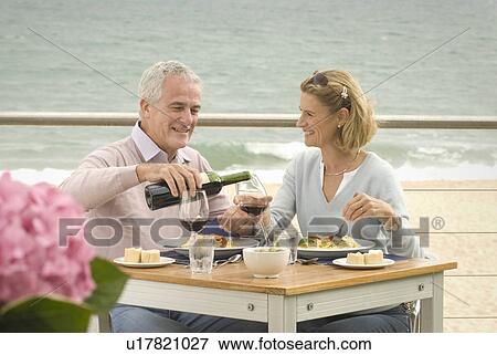 Stock Photo - Couple dining at seaside restaurant. Fotosearch