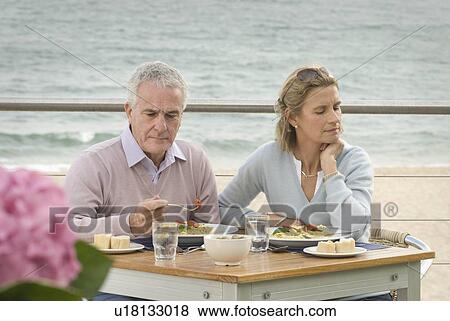 Stock Photo - Couple dining at seaside restaurant. Fotosearch