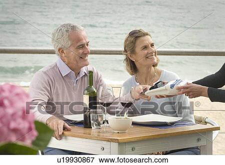 Stock Photo - Couple dining at seaside restaurant. Fotosearch