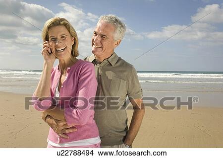 Picture - Couple embracing on a beach. Fotosearch