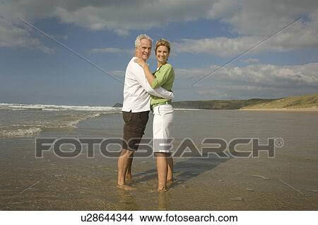 Couple embracing on a beach View Large Photo Image Picture - Couple embracing on a beach. Fotosearch